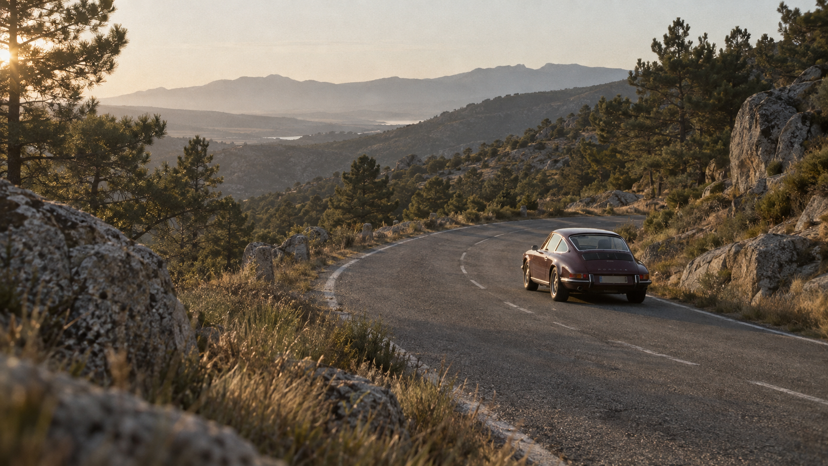 An aubergine early 911 on a road through the Sierra de Guadarrama